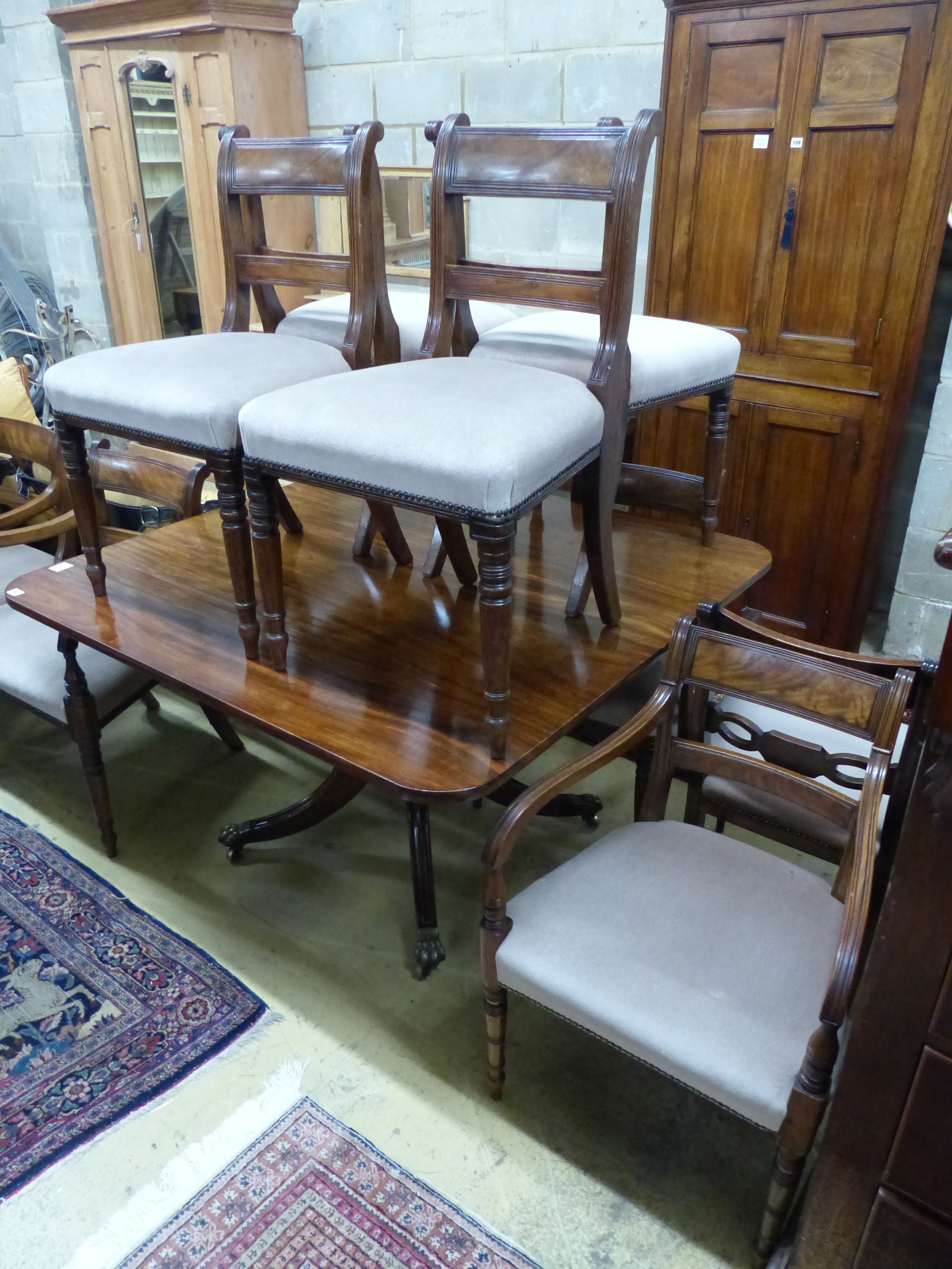 A Regency mahogany tilt top dining table, together with a harlequin set of ten Regency mahogany dining chairs (four with arms), table 122 x 118cm H.72cm